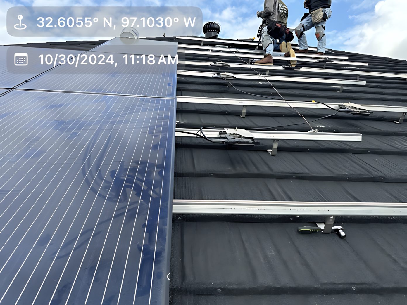 Solar panels are being installed on the roof of a building